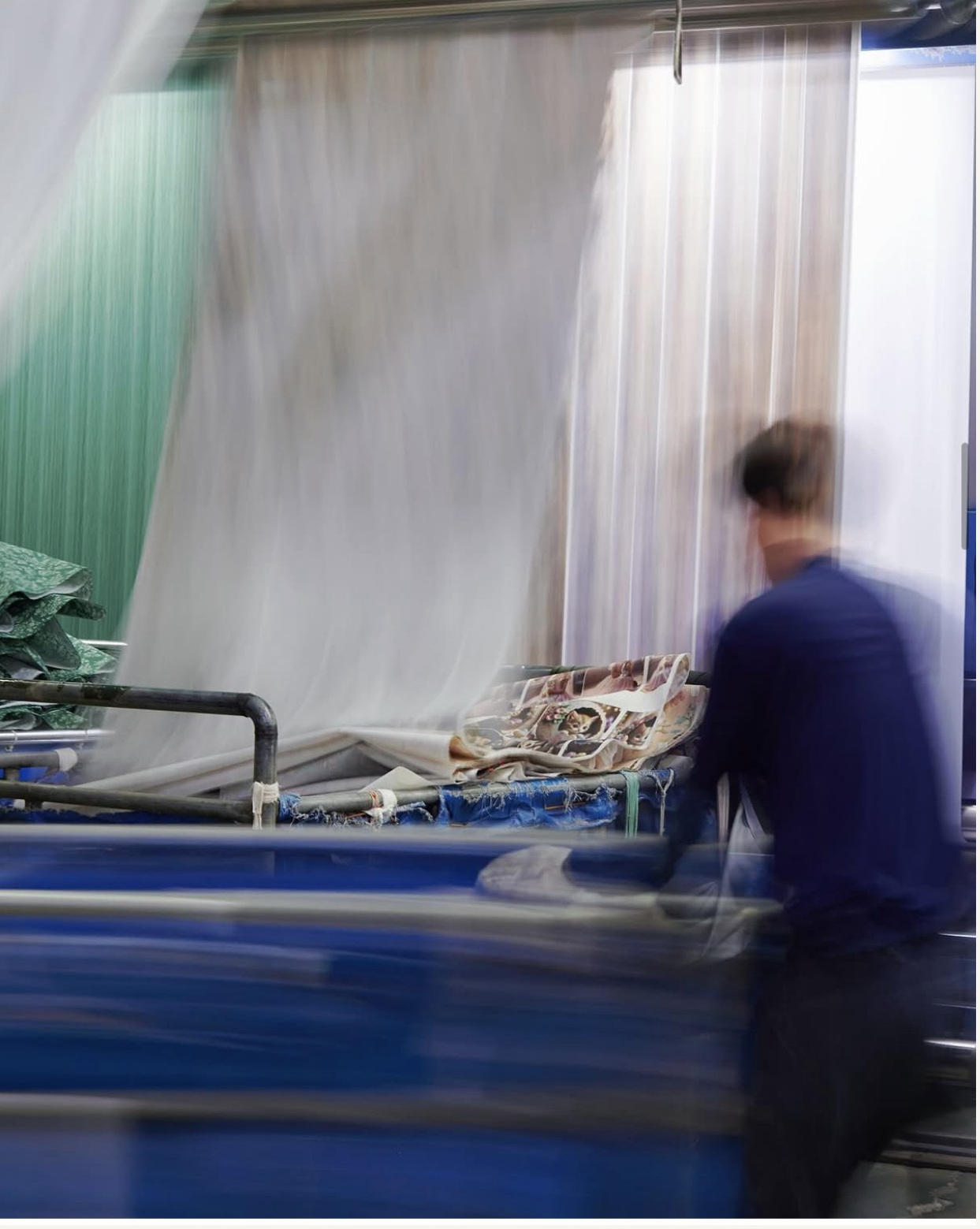 Textile worker handling fabric in the factory